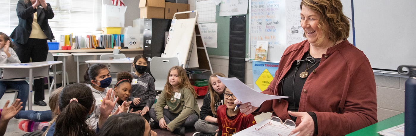 students being read to by a guest speaker